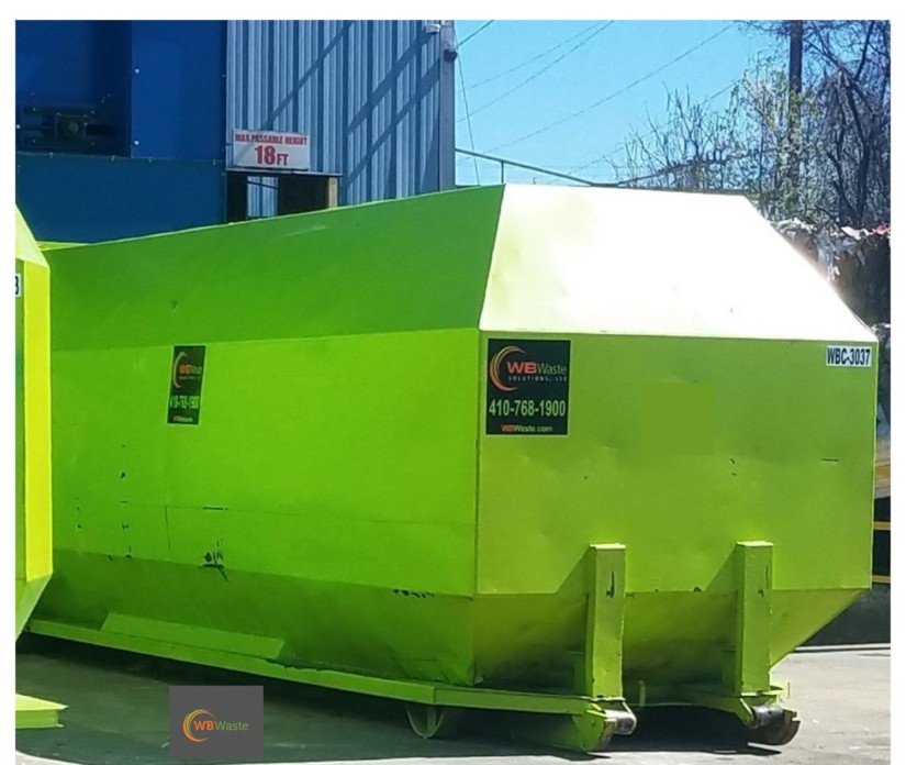 Large bright green WB Waste compactor outside