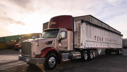White and maroon tractor trailer truck.